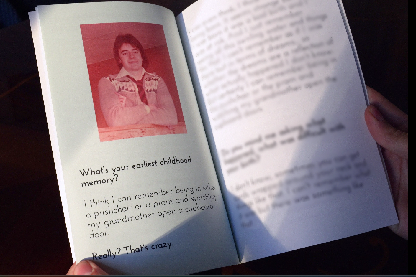 Open book with a red portrait and text on a dark background