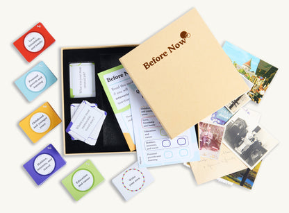 Birds eye view image of guided autobiograhy and life history collection kit Before Now. Image features carefully crafted conversation question cards, family memories photographs, instructions and Before Now autbiography kit book.