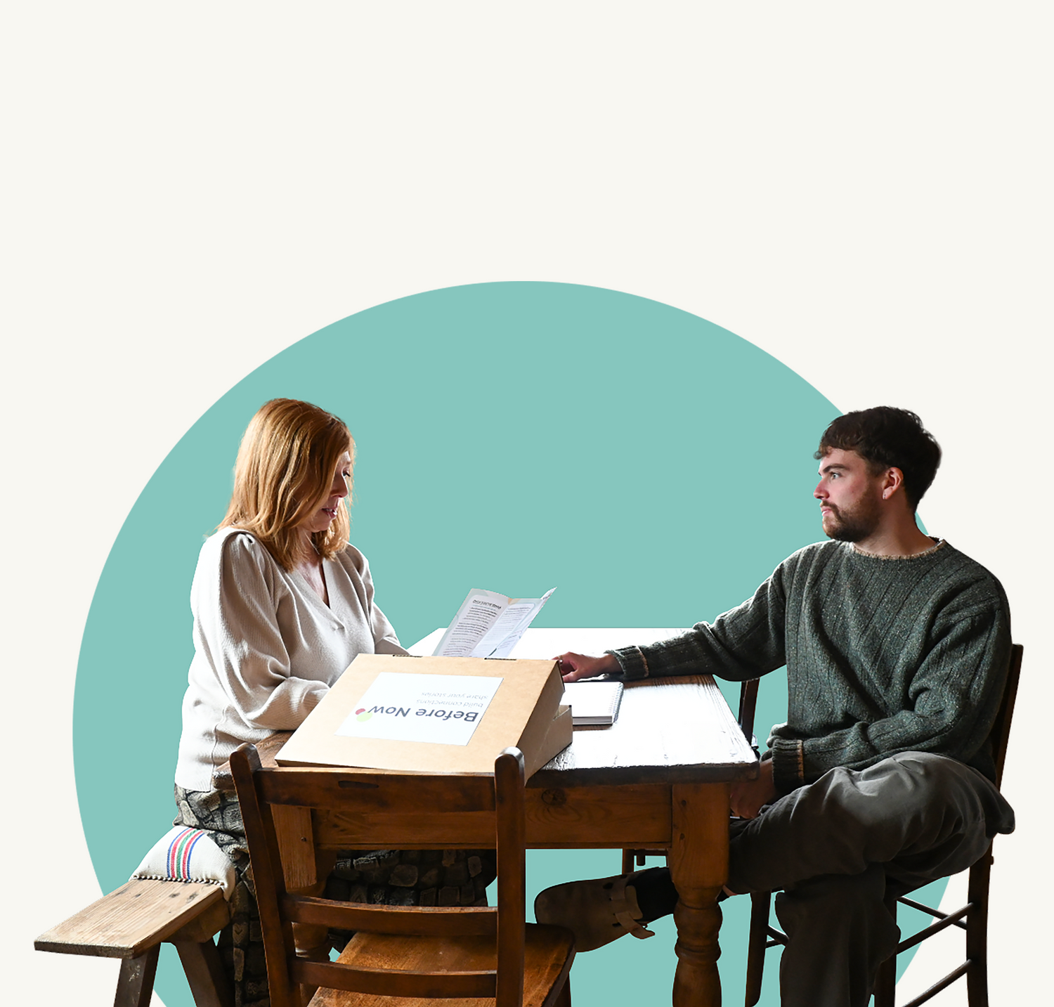 A mother and son at at a table after using Before Now to feel more connected to older relatives through using interview cards to help talk to grandparents and parents